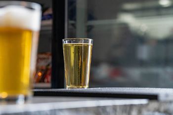 a glass of beer on a table  at Franklin Square Apartments/Townhomes, New Freedom